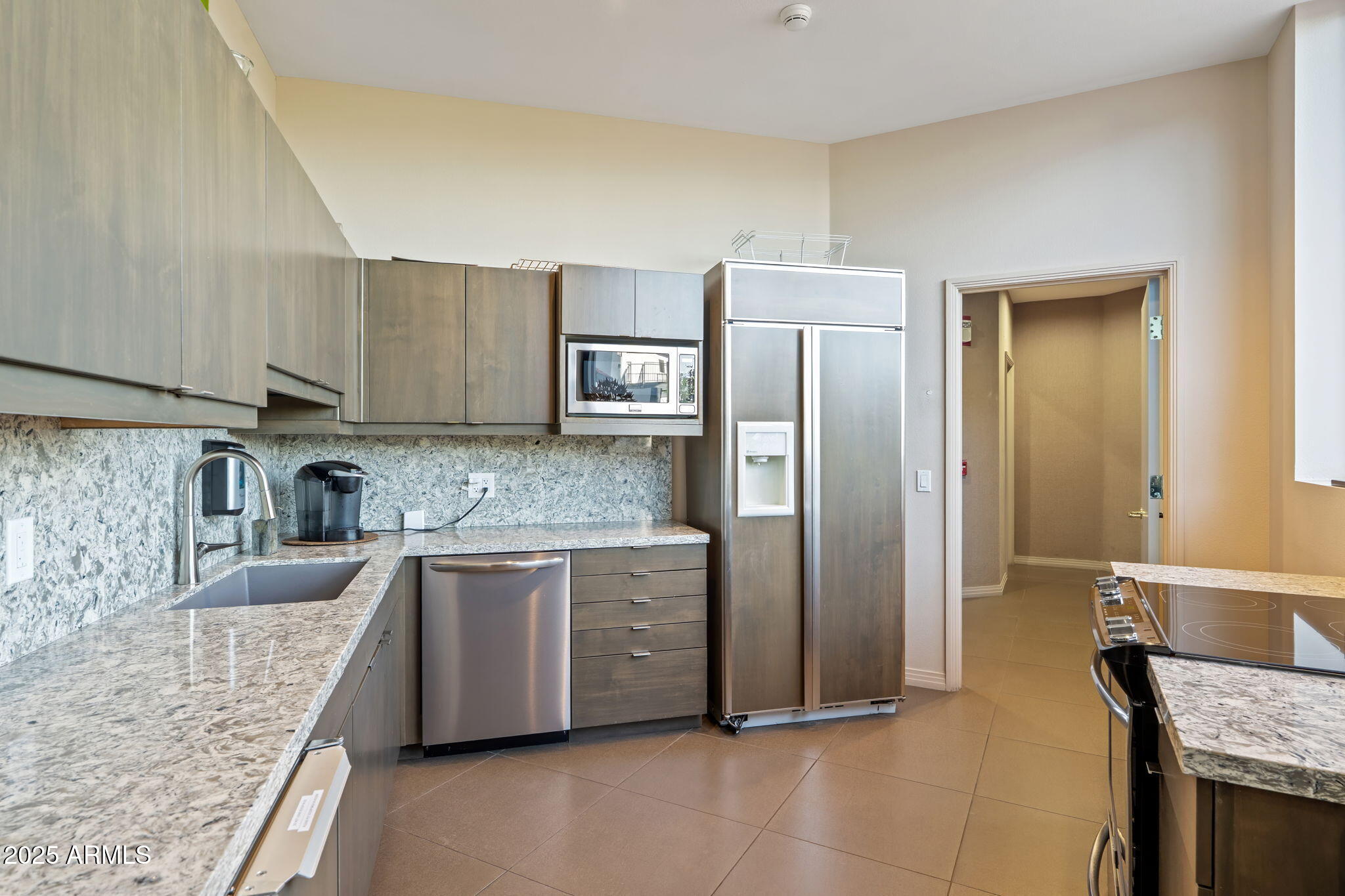 1040 East Osborn Road, Unit 1602 Phoenix, AZ 85014 - Photo 6 of 66 a kitchen with stainless steel appliances granite countertop a refrigerator and a stove