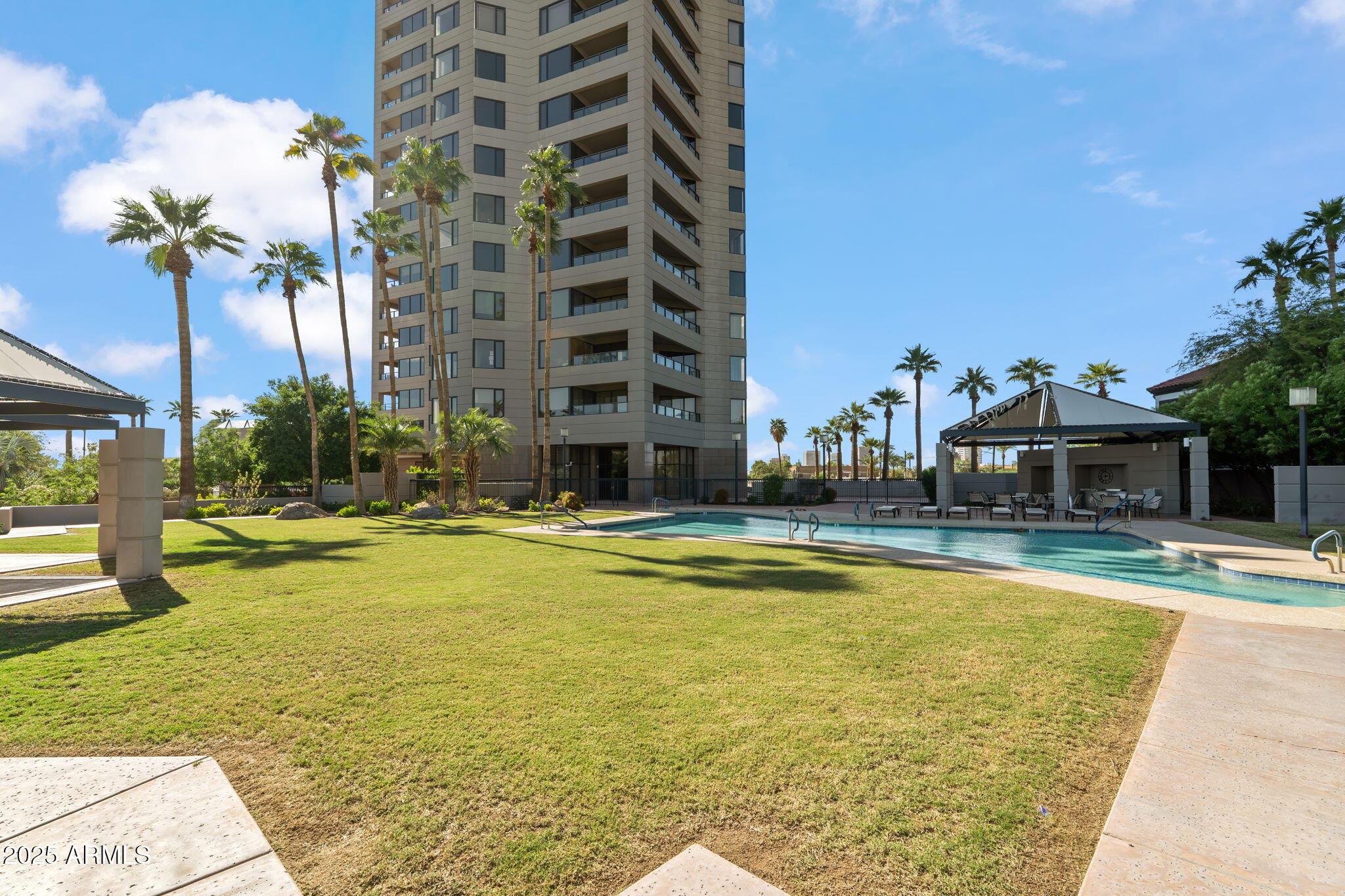 1040 East Osborn Road, Unit 1602 Phoenix, AZ 85014 - Photo 64 of 66 a view of a swimming pool with a lounge chairs