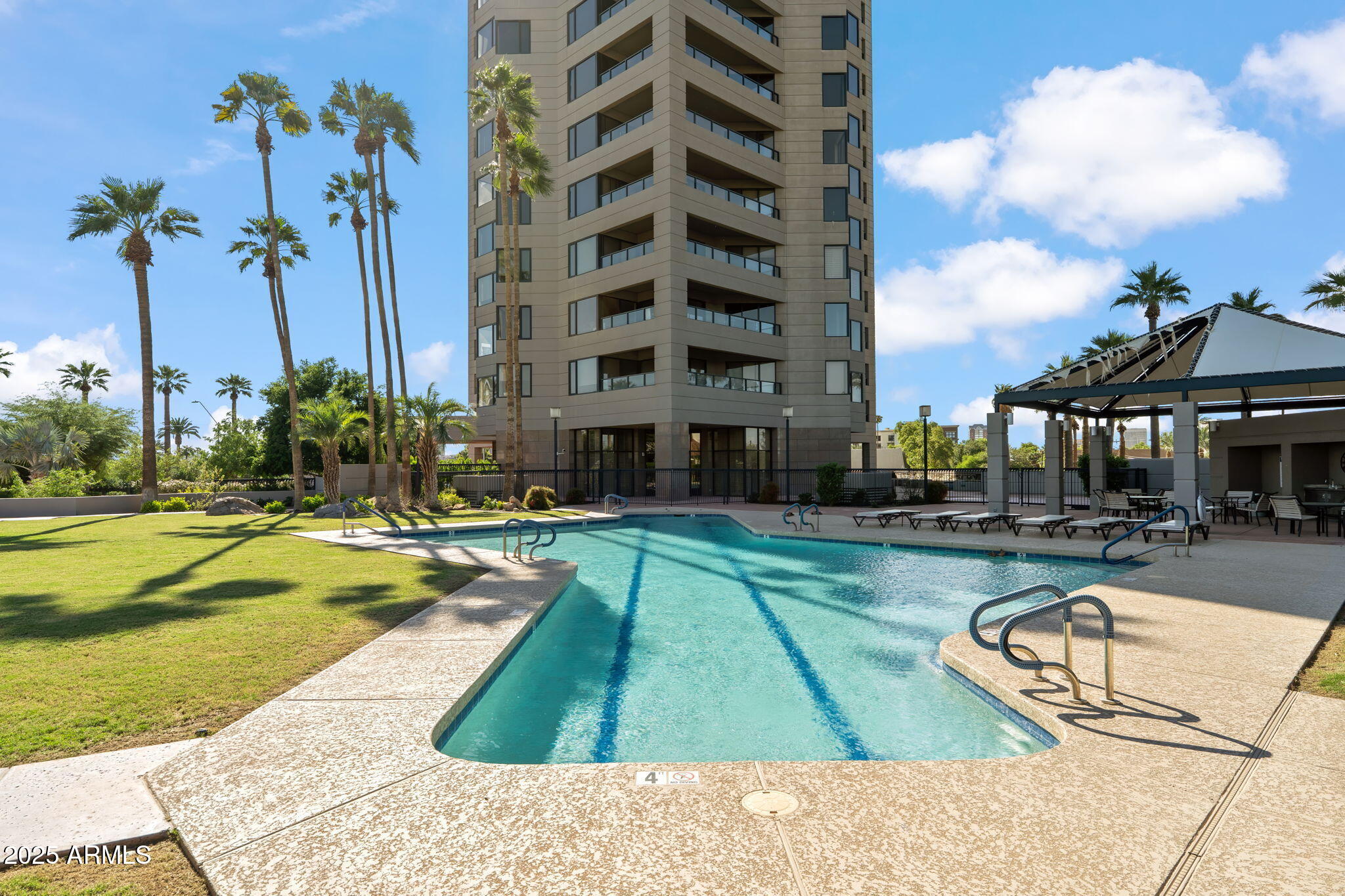 1040 East Osborn Road, Unit 1602 Phoenix, AZ 85014 - Photo 65 of 66 a swimming pool with outdoor seating and yard