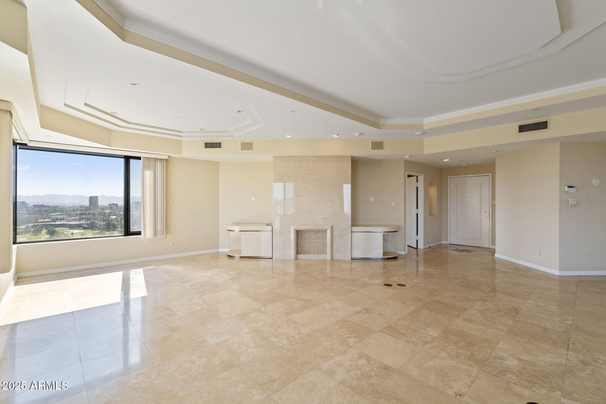 1040 East Osborn Road, Unit 1602 Phoenix, AZ 85014 - Photo 8 of 66 a view of an empty room with window and a kitchen