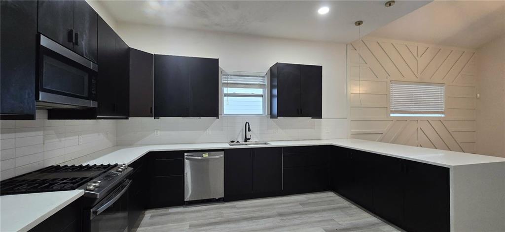 762 Cooper Street Southwest Atlanta, GA 30315 - Photo 12 of 43 a kitchen with stainless steel appliances a sink stove and cabinets