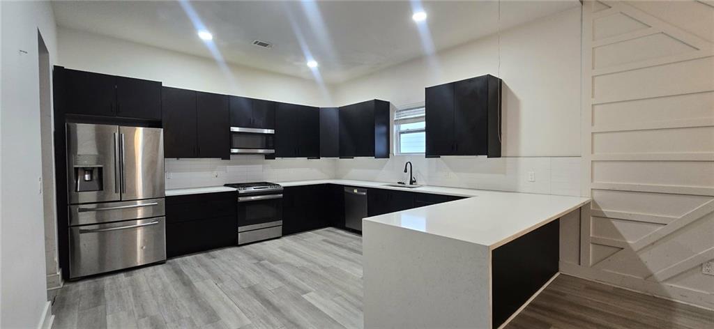 762 Cooper Street Southwest Atlanta, GA 30315 - Photo 13 of 43 a kitchen with a sink a stove a refrigerator and cabinets