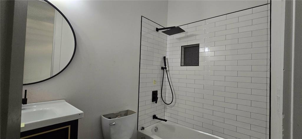 762 Cooper Street Southwest Atlanta, GA 30315 - Photo 14 of 43 a bathroom with a sink toilet and shower