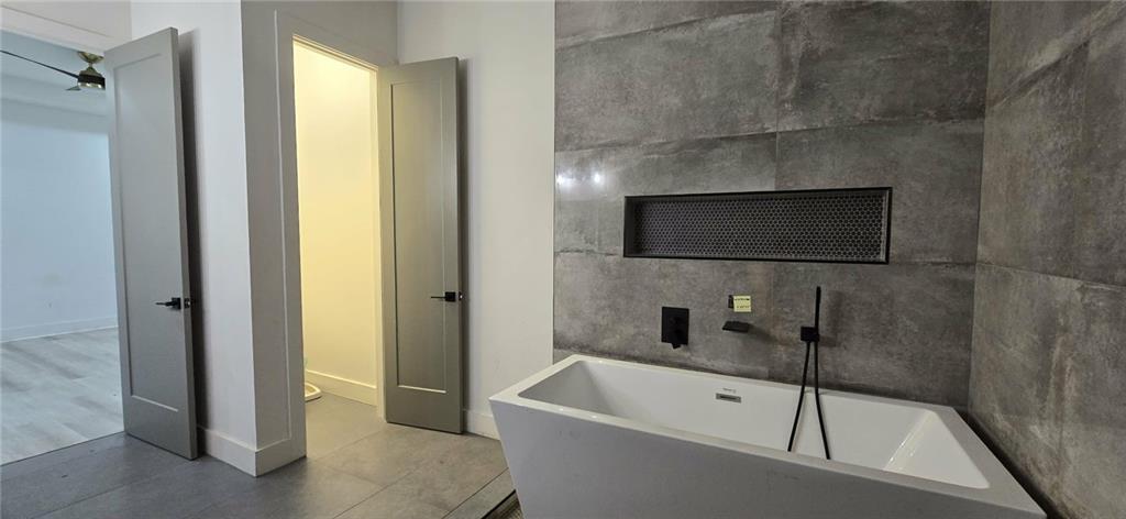 762 Cooper Street Southwest Atlanta, GA 30315 - Photo 16 of 43 a bathroom with a tub and a shower