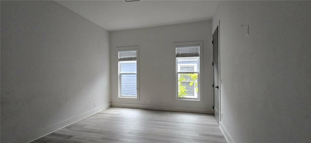 762 Cooper Street Southwest Atlanta, GA 30315 - Photo 22 of 43 an empty room with wooden floor and windows