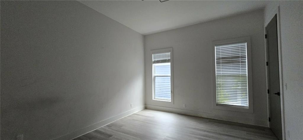 762 Cooper Street Southwest Atlanta, GA 30315 - Photo 24 of 43 a view of an empty room with wooden floor and a window