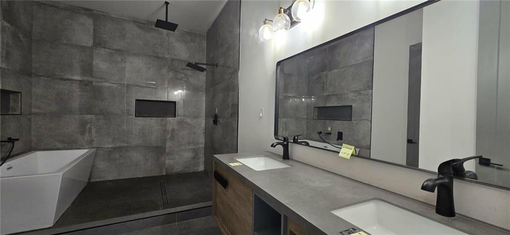 762 Cooper Street Southwest Atlanta, GA 30315 - Photo 27 of 43 a bathroom with a sink double vanity granite tub shower and mirror