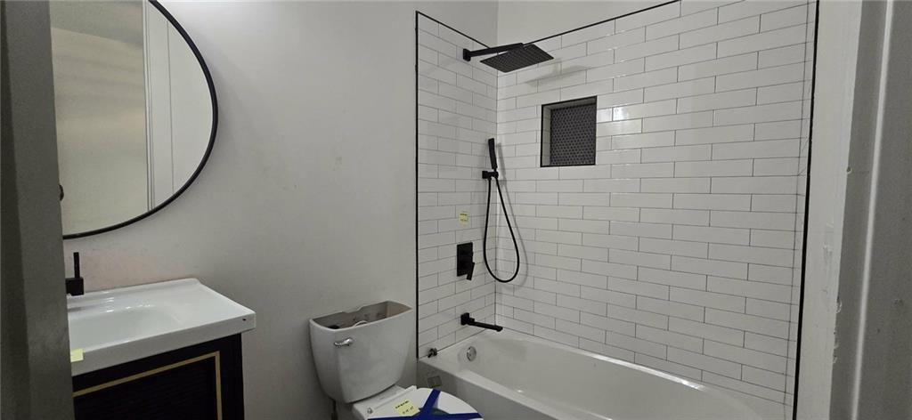 762 Cooper Street Southwest Atlanta, GA 30315 - Photo 32 of 43 a bathroom with a sink a toilet and shower