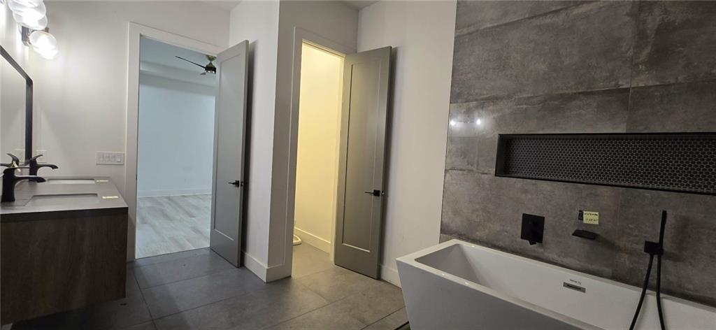 762 Cooper Street Southwest Atlanta, GA 30315 - Photo 34 of 43 a bathroom with a double vanity sink a toilet and a mirror