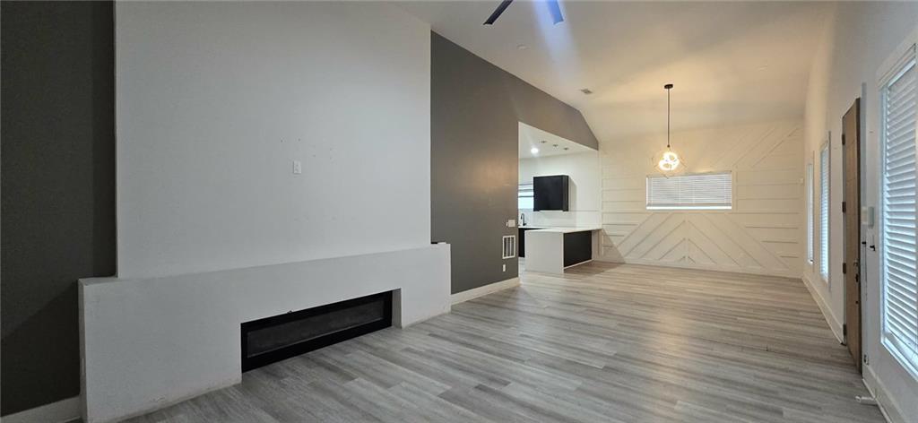 762 Cooper Street Southwest Atlanta, GA 30315 - Photo 5 of 43 a view of a kitchen with kitchen island a sink wooden floor and living room view