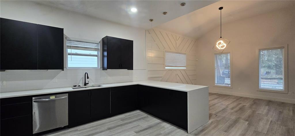 762 Cooper Street Southwest Atlanta, GA 30315 - Photo 7 of 43 a kitchen with a sink dishwasher and a wooden floor