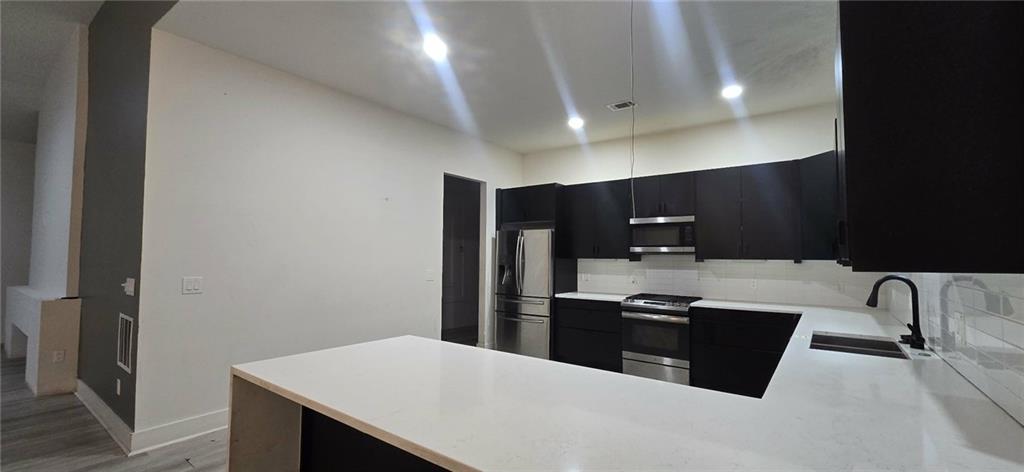 762 Cooper Street Southwest Atlanta, GA 30315 - Photo 8 of 43 a kitchen with stainless steel appliances a refrigerator and a stove