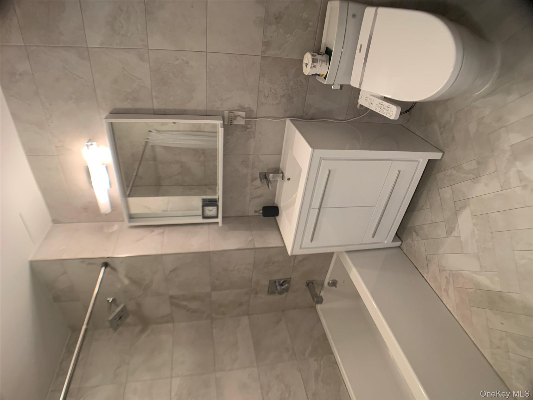 109-19 72nd Road, Unit 4C Queens, NY 11375 - Photo 11 of 16 a bathroom with a sink a toilet and bathtub