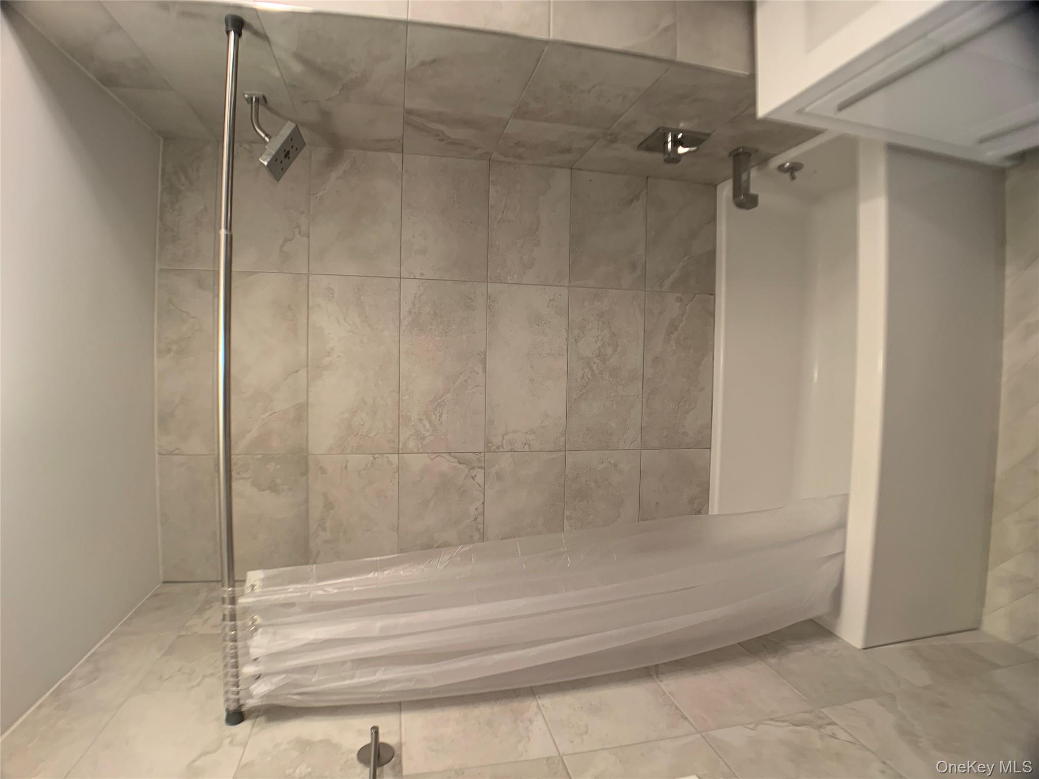 109-19 72nd Road, Unit 4C Queens, NY 11375 - Photo 12 of 16 a bathroom with a shower and a bath tub