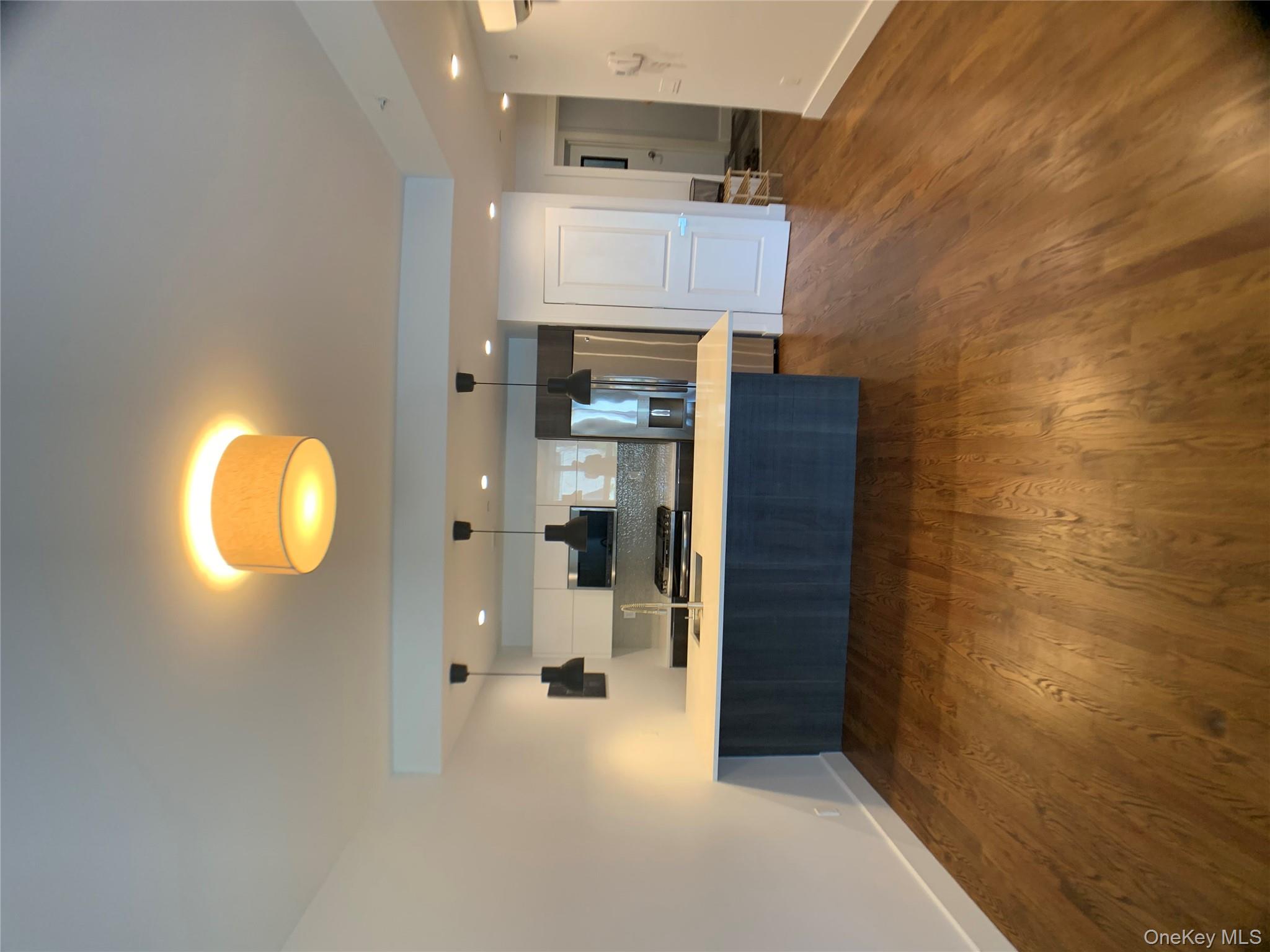 109-19 72nd Road, Unit 4C Queens, NY 11375 - Photo 2 of 16 a kitchen with kitchen island a sink dishwasher and a stove with wooden floor
