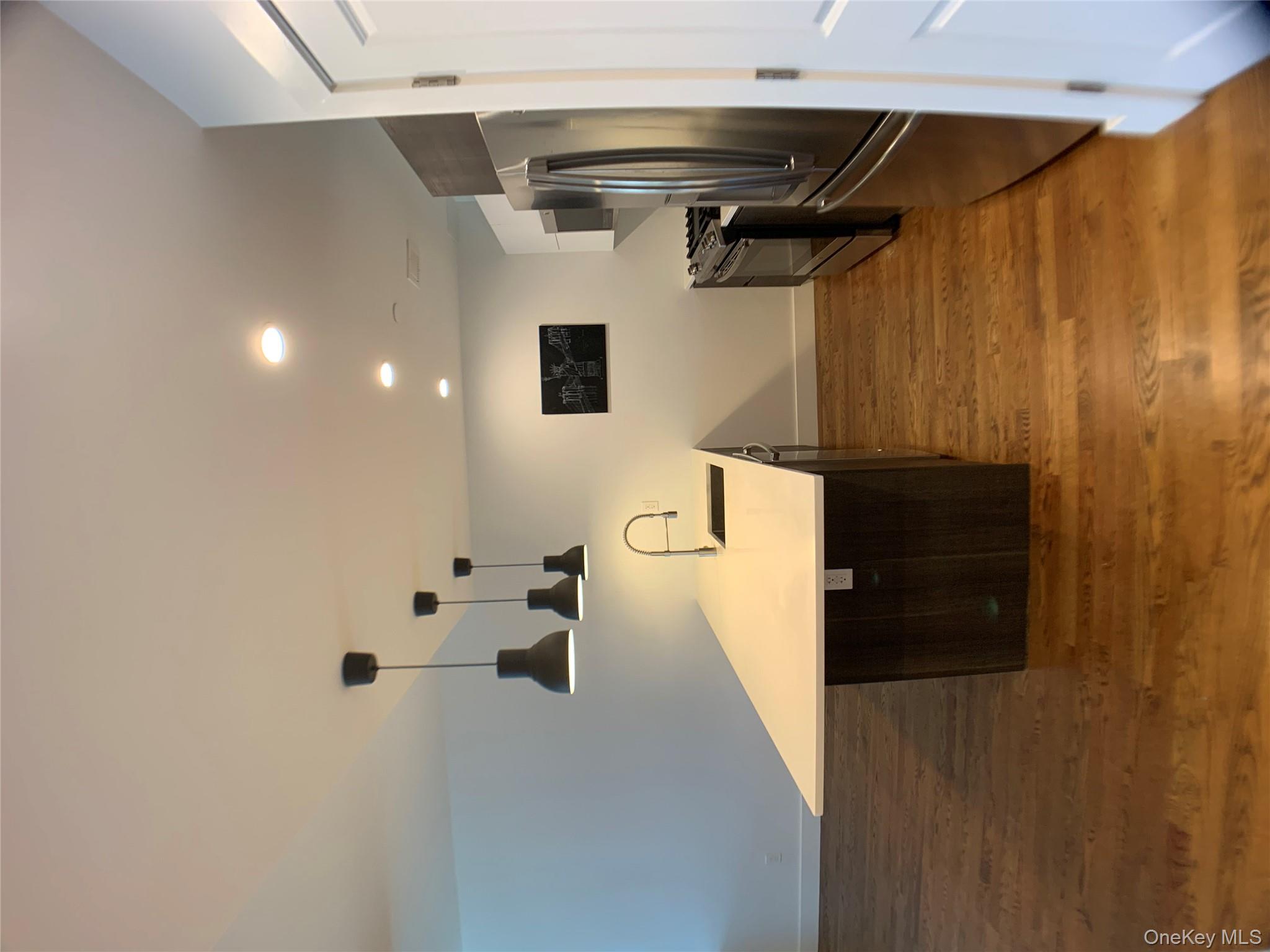 109-19 72nd Road, Unit 4C Queens, NY 11375 - Photo 3 of 16 a view of a kitchen with a sink stainless steel appliances and cabinets