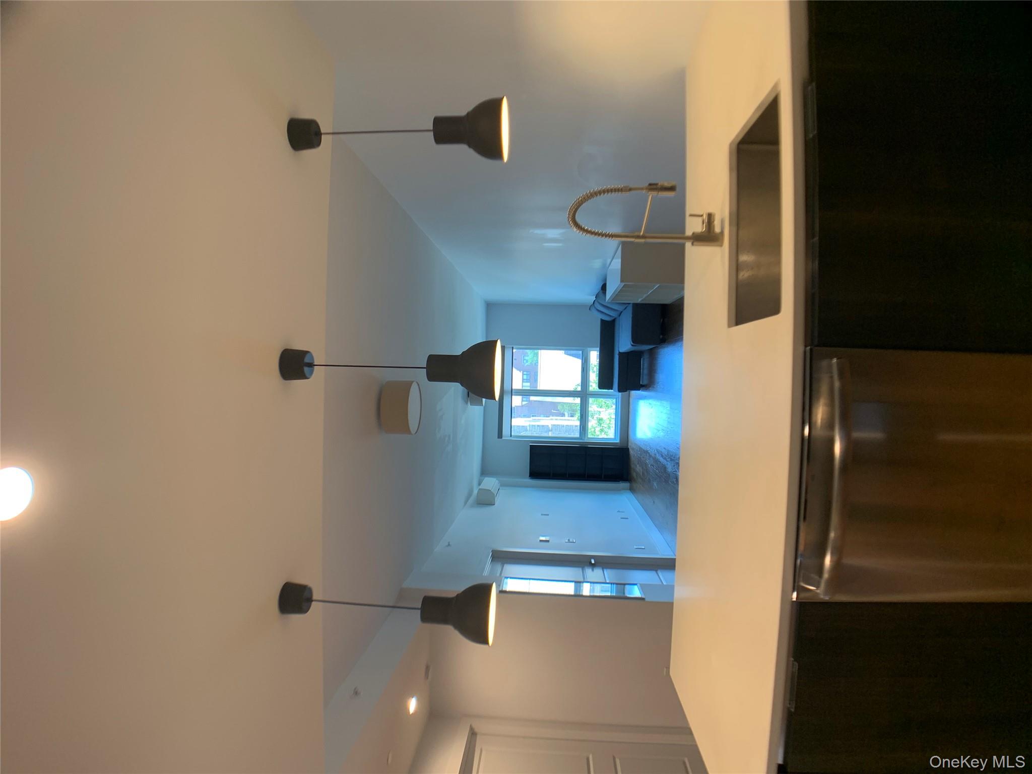 109-19 72nd Road, Unit 4C Queens, NY 11375 - Photo 4 of 16 a kitchen with a sink and a chandelier