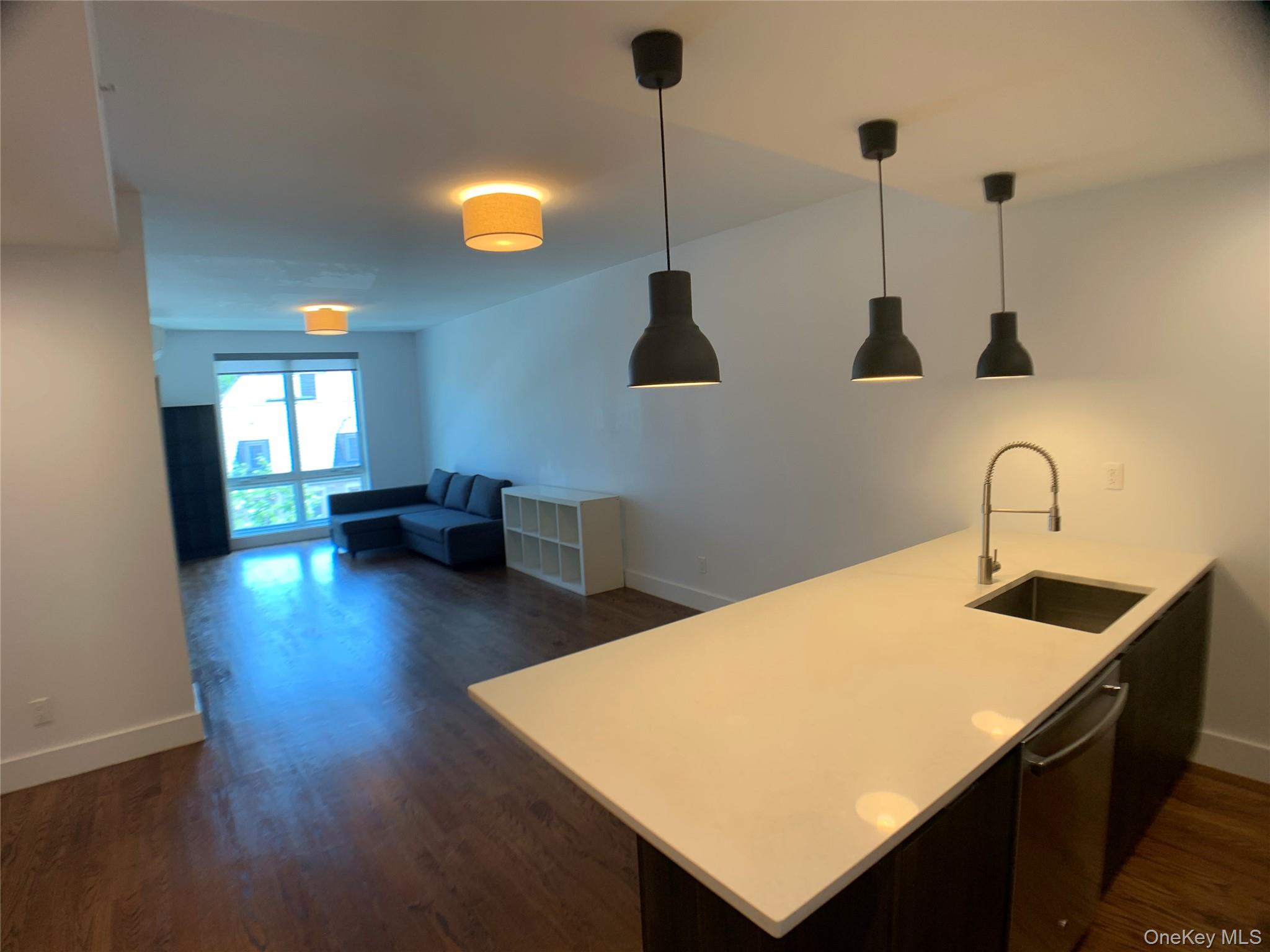 109-19 72nd Road, Unit 4C Queens, NY 11375 - Photo 6 of 16 a kitchen with stainless steel appliances granite countertop a sink a stove and a wooden floor