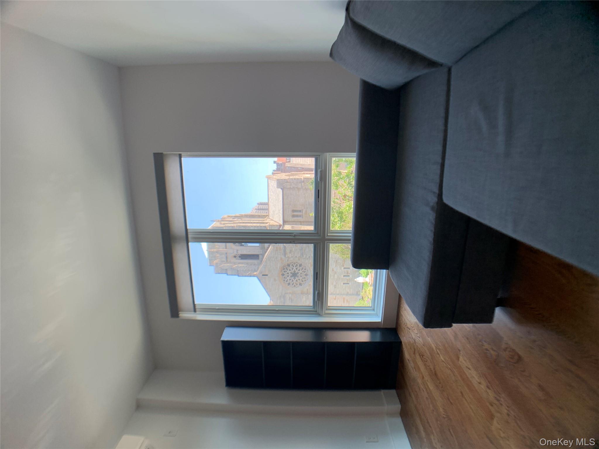 109-19 72nd Road, Unit 4C Queens, NY 11375 - Photo 8 of 16 a living room with furniture and a large window