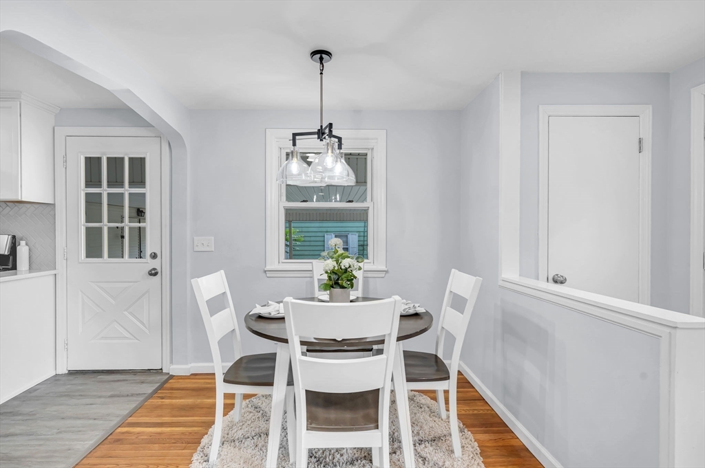 13 Lorimer Street Chicopee, MA 01013 - Photo 12 of 42 a dining room with furniture a chandelier and wooden floor