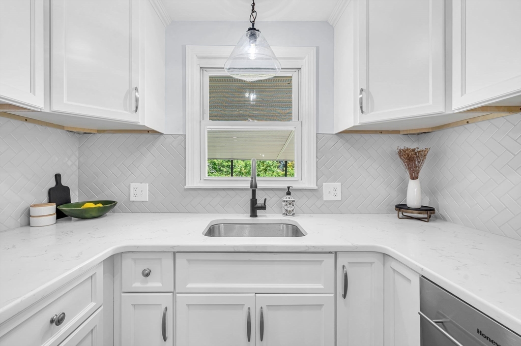 13 Lorimer Street Chicopee, MA 01013 - Photo 16 of 42 a kitchen with white cabinets and a sink