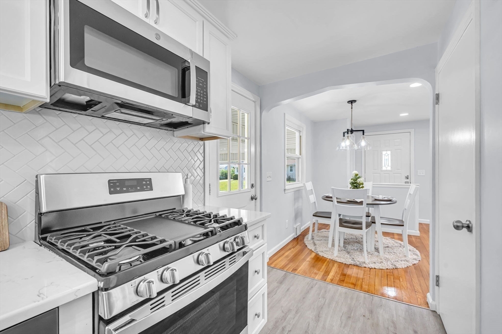 13 Lorimer Street Chicopee, MA 01013 - Photo 17 of 42 a kitchen with a stove and a wooden floor