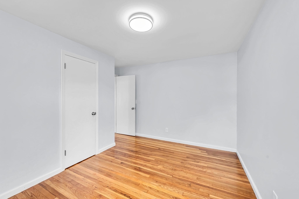 13 Lorimer Street Chicopee, MA 01013 - Photo 20 of 42 a view of empty room with wooden floor