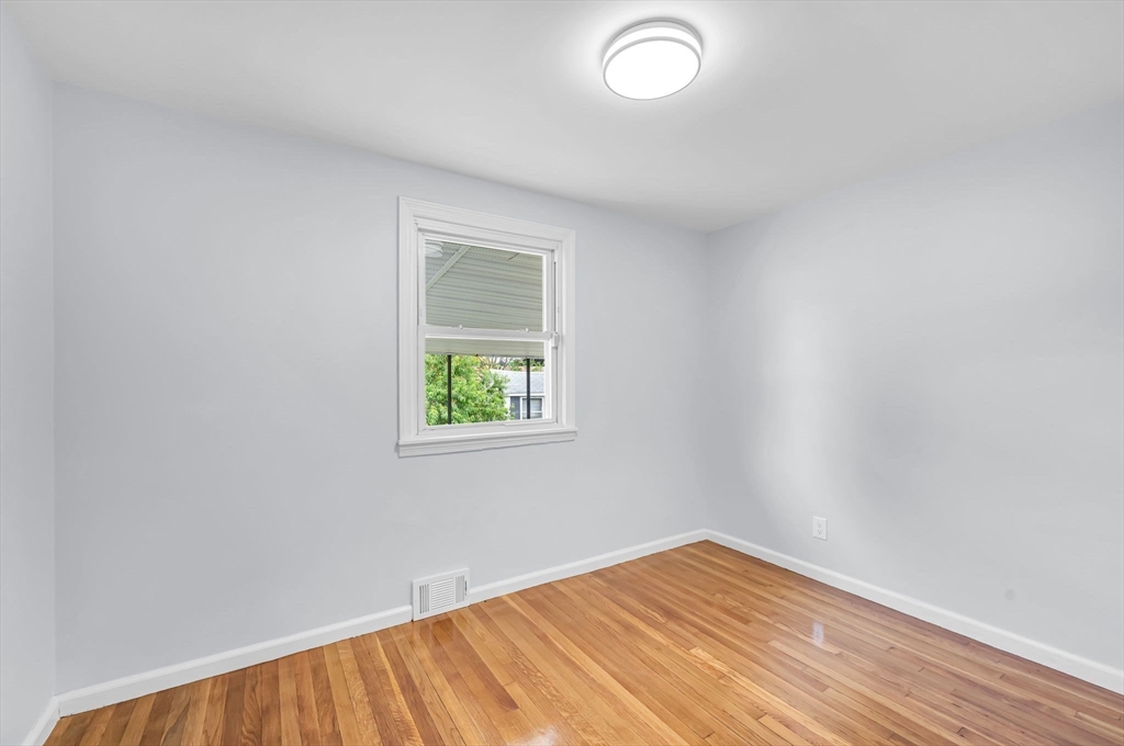 13 Lorimer Street Chicopee, MA 01013 - Photo 24 of 42 an empty room with wooden floor and windows