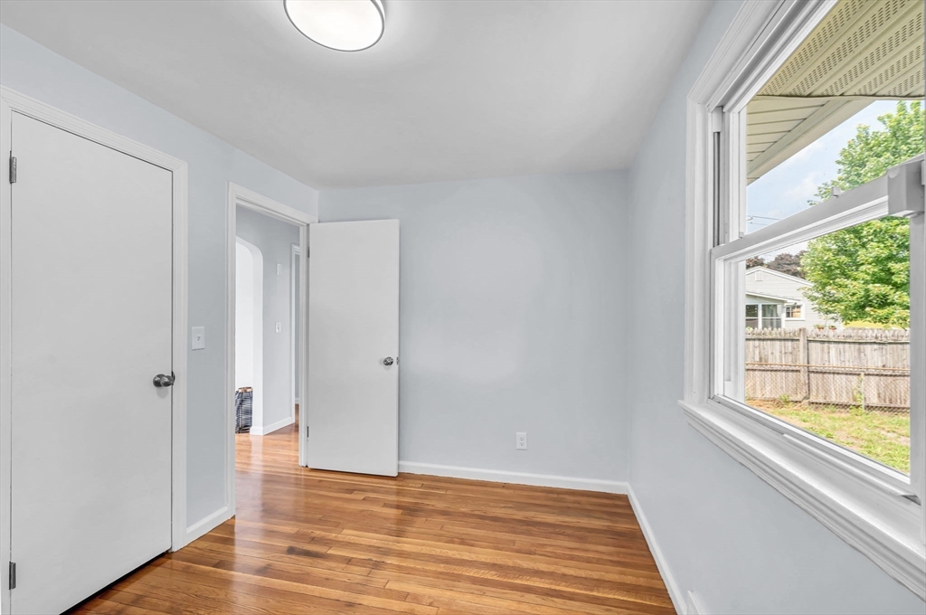 13 Lorimer Street Chicopee, MA 01013 - Photo 25 of 42 a view of an empty room with wooden floor and a window