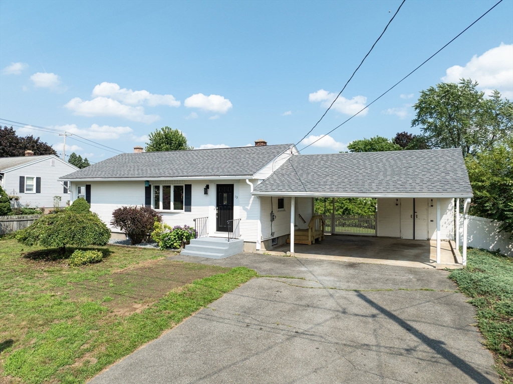 13 Lorimer Street Chicopee, MA 01013 - Photo 42 of 42 a front view of a house with a yard and potted plants