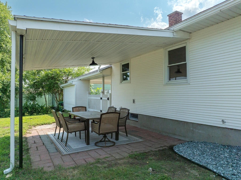 13 Lorimer Street Chicopee, MA 01013 - Photo 7 of 42 a view of a patio with a table and chairs