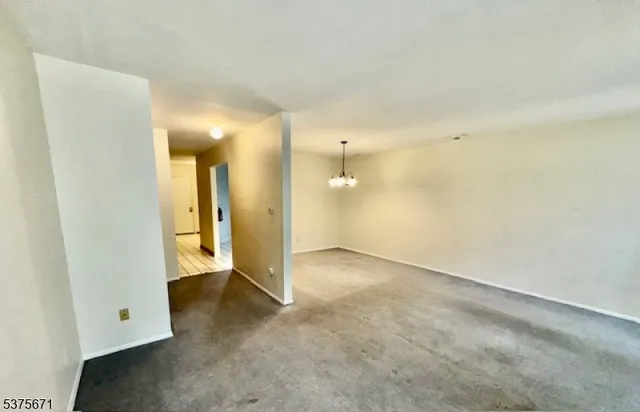 an empty room with a bathroom and a sink