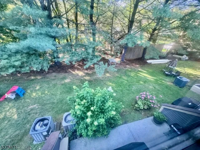 a backyard of a house with lots of green space and lake view