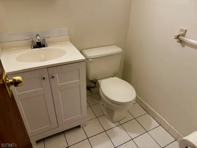 a white toilet sitting next to a bathroom sink