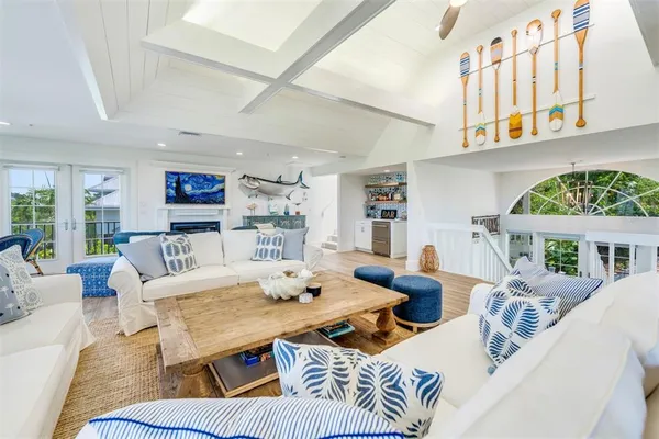 a living room with furniture fireplace and a table