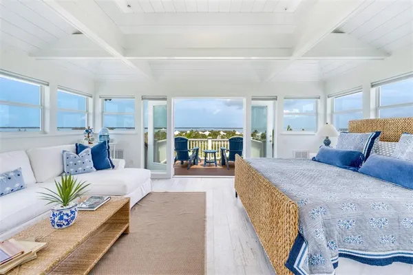 a large bedroom with a large bed and a large window