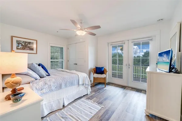 a bedroom with furniture and a large window