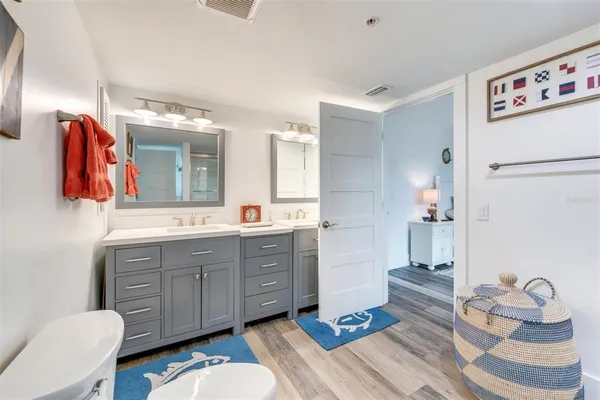 a spacious bathroom with a toilet a sink and a mirror