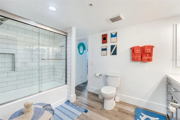a bathroom with a toilet and a shower