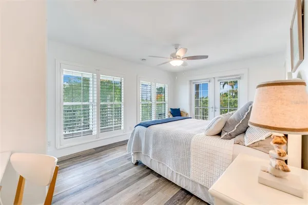 a bedroom with a large bed and a large window