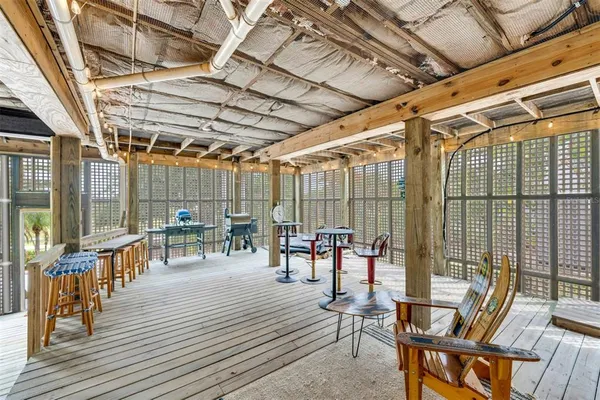 a view of a patio with table and chairs and wooden floor
