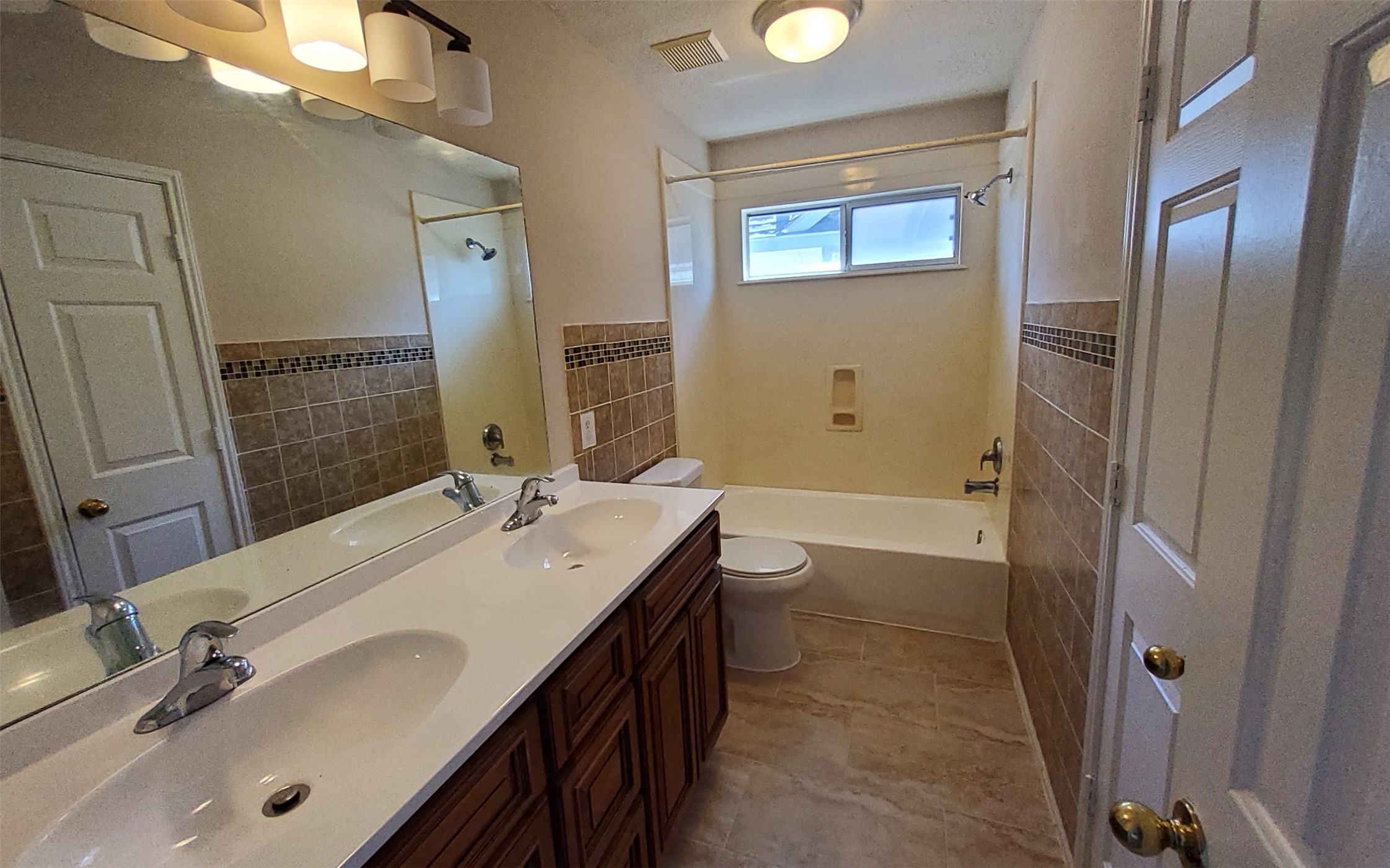 2906 Humble Drive Manvel, TX 77578 - Photo 24 of 34 a bathroom with a double vanity sink toilet mirror and bathtub