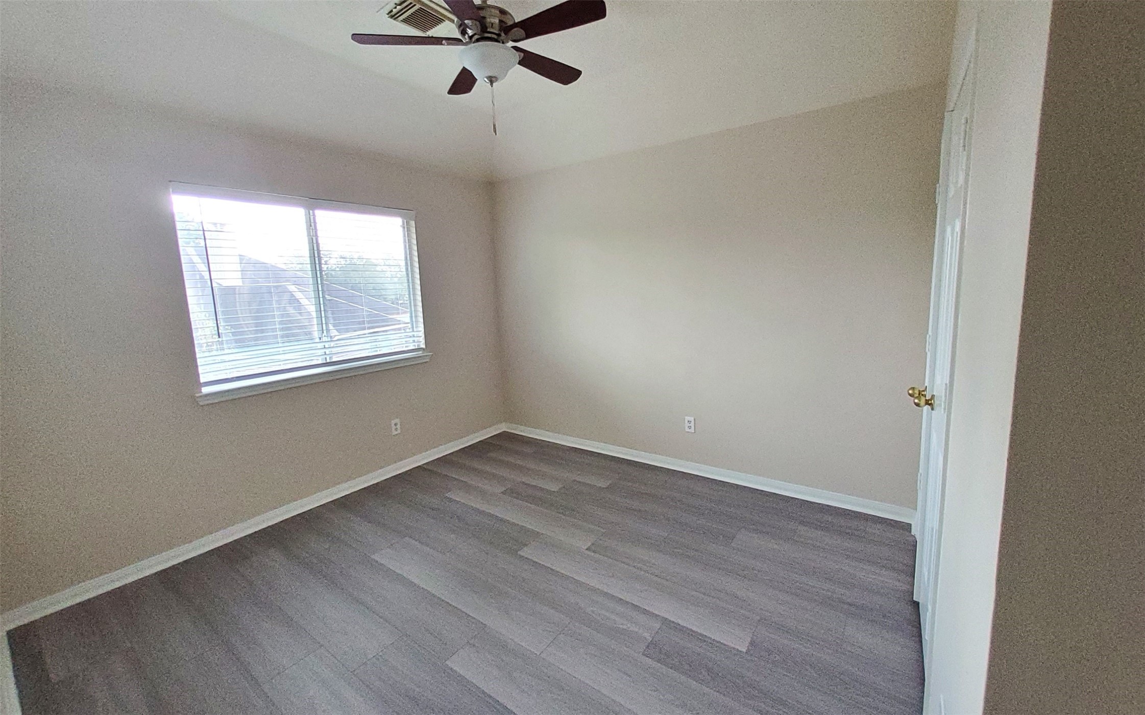 2906 Humble Drive Manvel, TX 77578 - Photo 27 of 34 a view of a room with wooden floor and windows