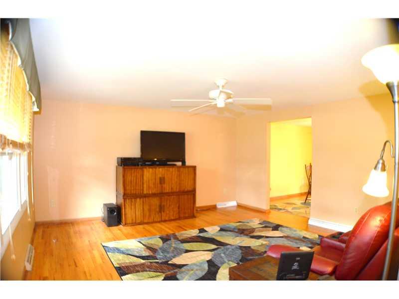 307 Foxcroft Road Pittsburgh, PA 15220 - Photo 12 of 23 Living Room. living room with hardwood and front wall of windows