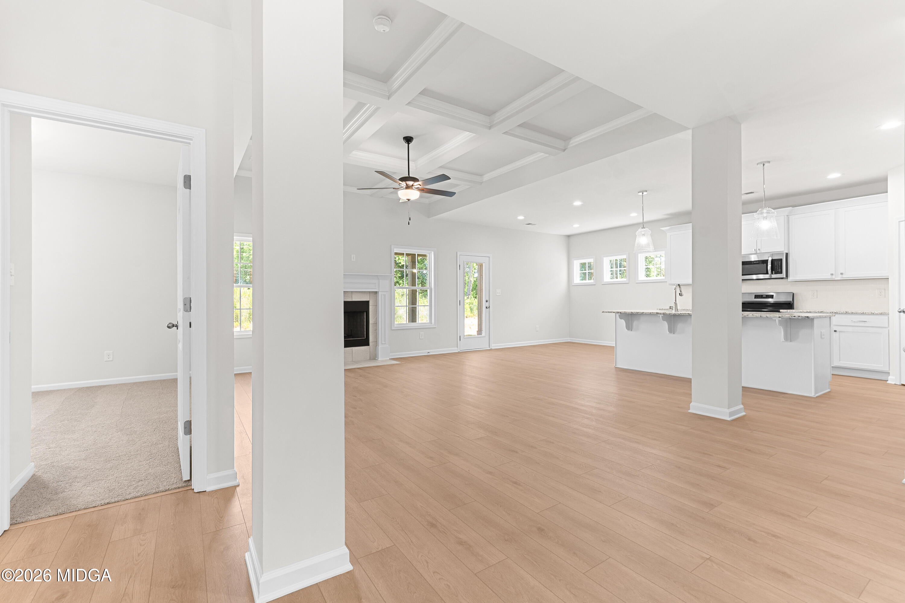 5393 Felles Way, Unit 359 Forsyth, GA 31029 - Photo 24 of 54 a view of an empty room and kitchen view with wooden floor