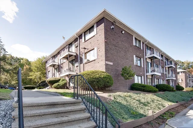 a view of a brick building with many windows