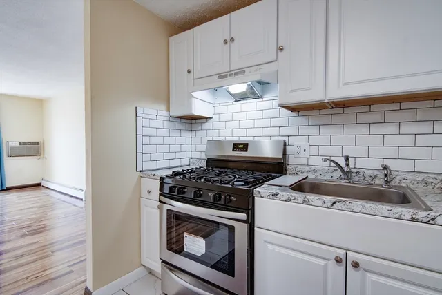 a kitchen with a stove and cabinets