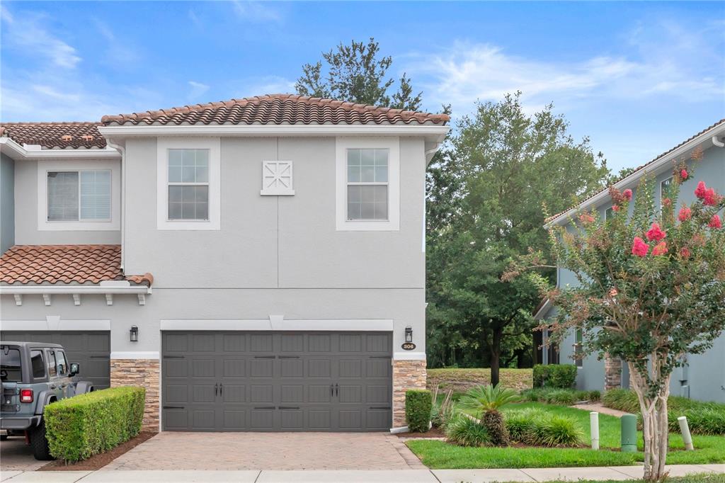 306 Reed Grass Drive Oviedo, FL 32765 - Photo 1 of 33 a front view of a house with a garden