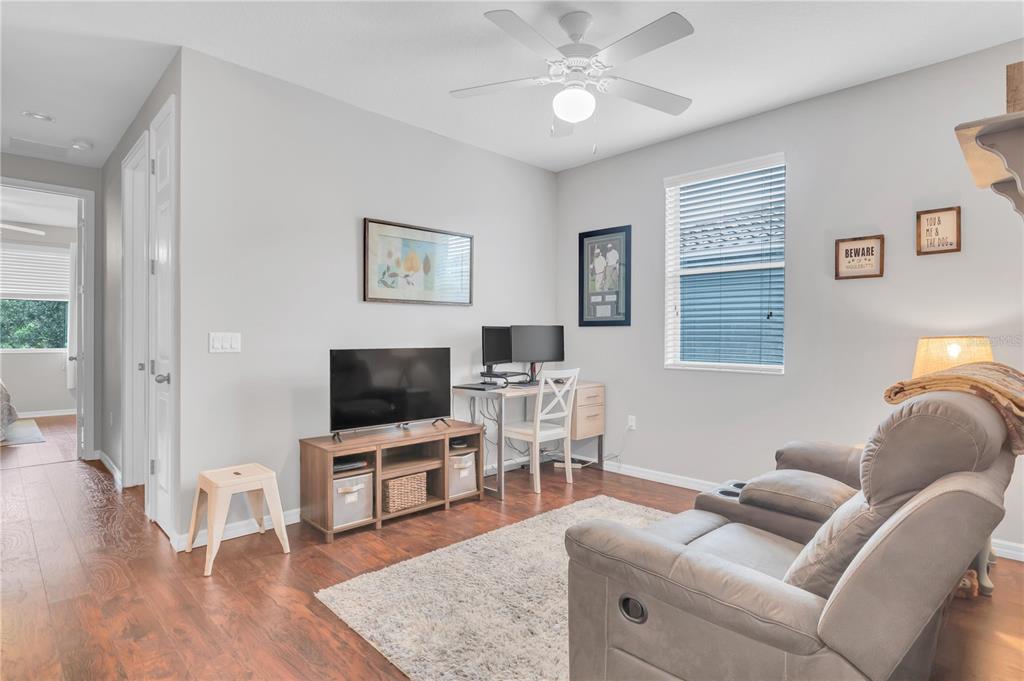 306 Reed Grass Drive Oviedo, FL 32765 - Photo 13 of 33 a living room with furniture and a flat screen tv