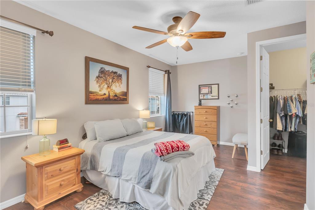 306 Reed Grass Drive Oviedo, FL 32765 - Photo 14 of 33 a bedroom with a bed and a chandelier